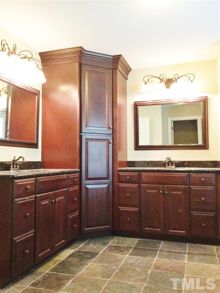 11604 Chipaway Court Raleigh, NC 27614 - Photo 14 of 25 a bathroom with a sink and a mirror