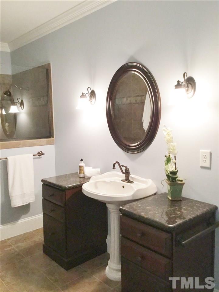 11604 Chipaway Court Raleigh, NC 27614 - Photo 8 of 25 a bathroom with a sink and a mirror