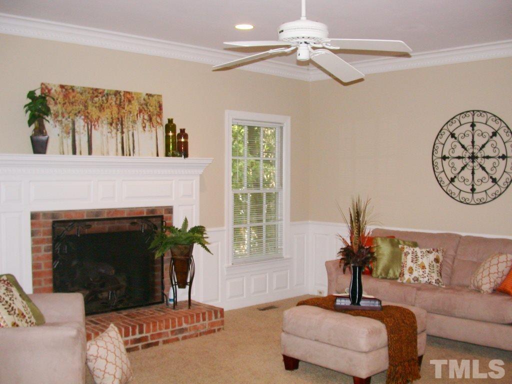 11604 Chipaway Court Raleigh, NC 27614 - Photo 10 of 25 a living room with furniture a window and a fireplace