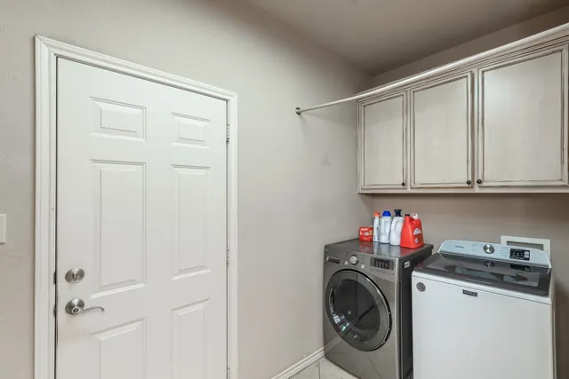 a utility room with sink dryer and washer
