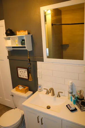 a bathroom with a sink toilet and mirror