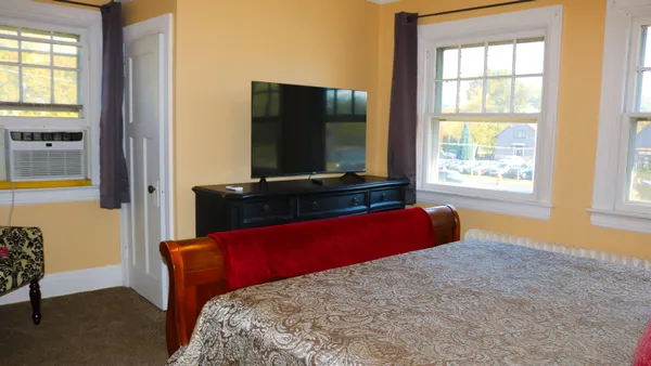 a bedroom with a bed and window