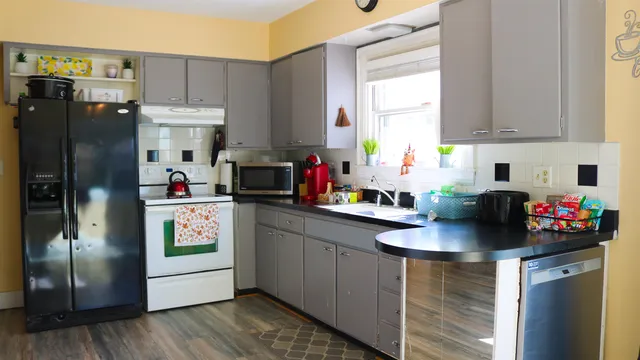 a kitchen with stainless steel appliances granite countertop a refrigerator sink and cabinets