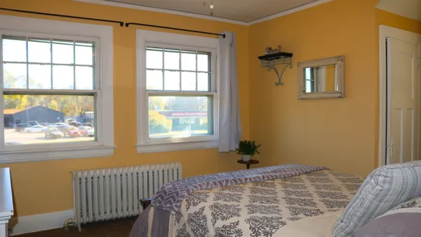 a bedroom with a bed and a window