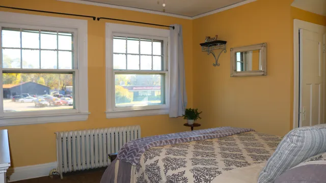 a bedroom with a bed and a window