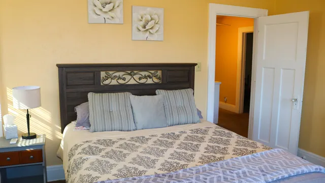 a bed sitting in a bedroom and a table