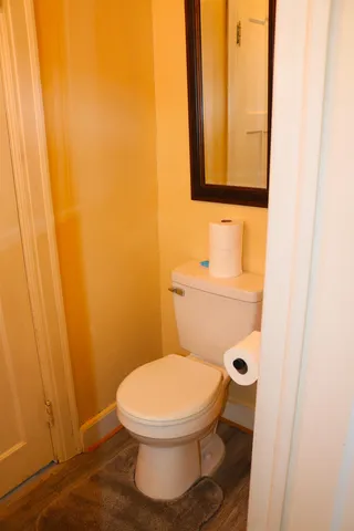 a white toilet sitting next to a small bathroom