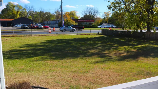 a backyard of a house with large trees