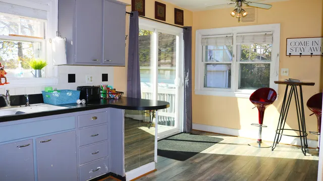 a kitchen with granite countertop a stove a sink and a window