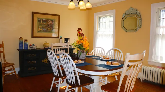 a view of a dining room with furniture and chandelier