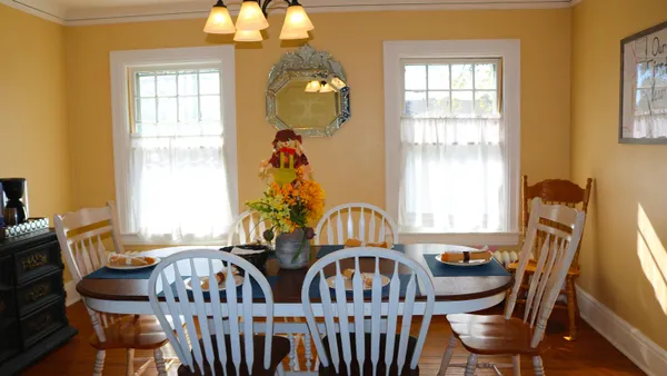 a view of a dining room with furniture and windows