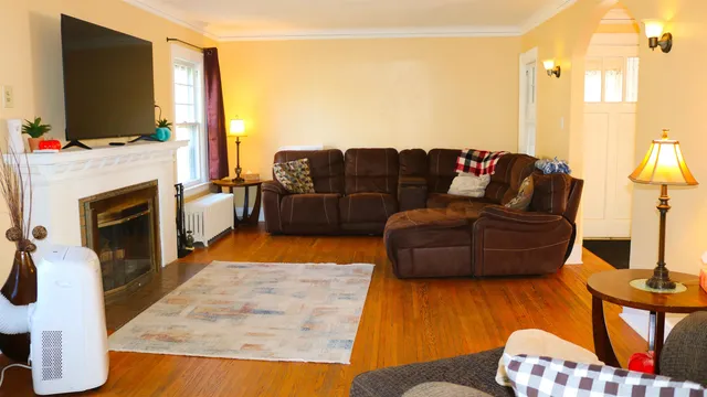 a living room with furniture fireplace and flat screen tv