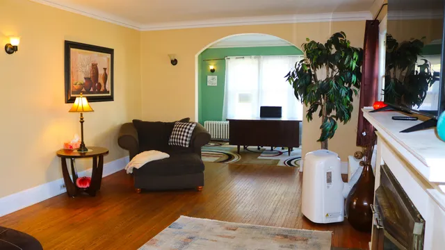 a living room with furniture and a potted plant