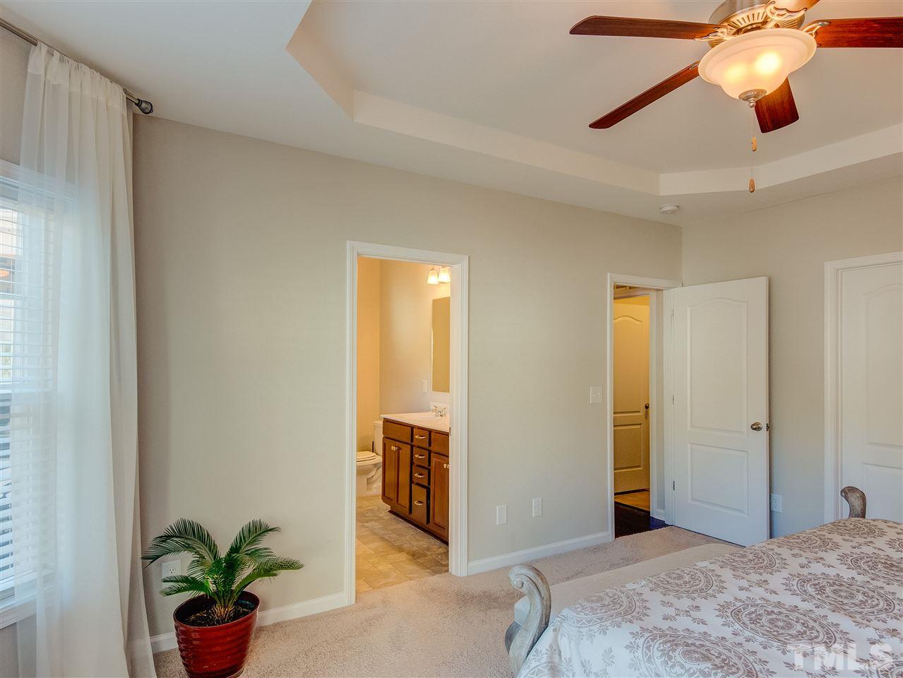 30 Mariners Point Way Garner, NC 27529 - Photo 13 of 25 Luxurious Master Bedroom with walk out bay window, spacious walk in closet, trey ceiling, fan with light and neutral upgraded carpet.