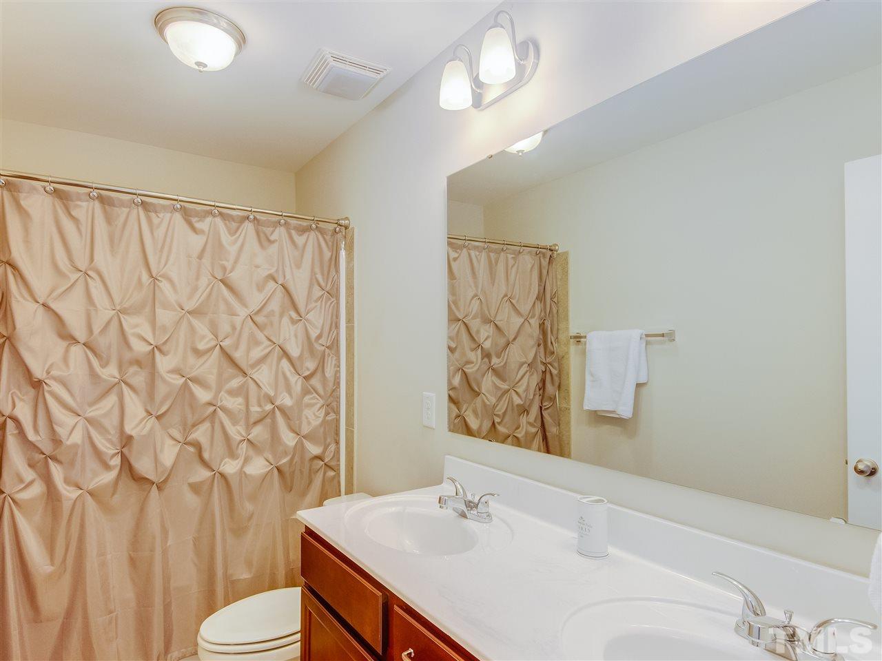 30 Mariners Point Way Garner, NC 27529 - Photo 21 of 25 Spacious Full bath with double sink vanity and bath tub/shower combo.