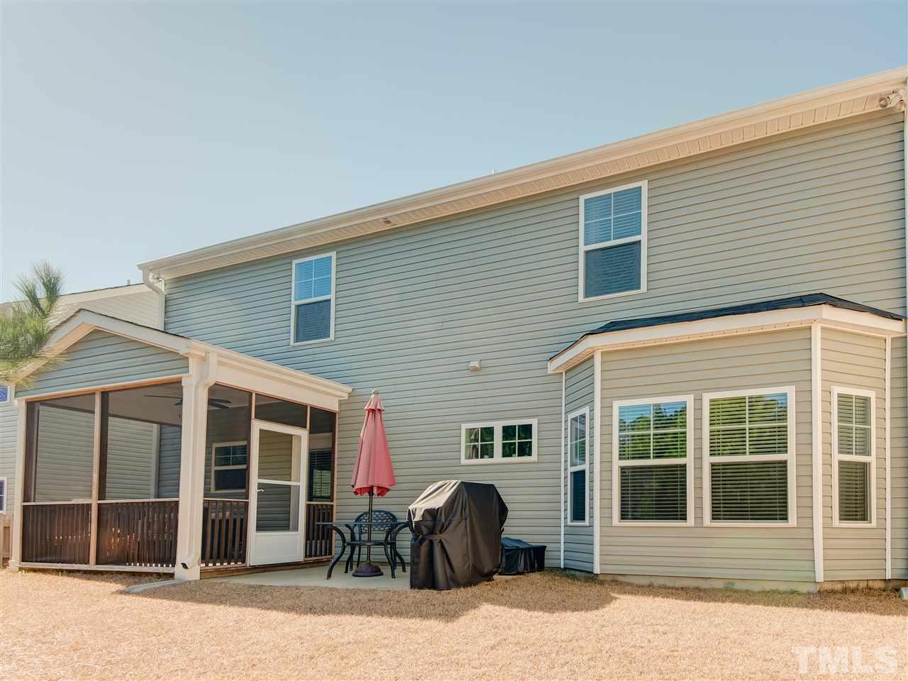 30 Mariners Point Way Garner, NC 27529 - Photo 24 of 25 Back of house features include screened porch, patio ... all overlooking the trees in the fenced back yard.