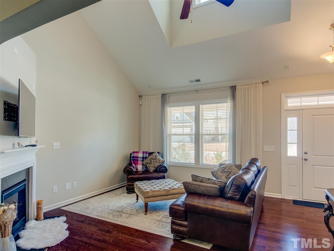 30 Mariners Point Way Garner, NC 27529 - Photo 5 of 25 Gorgeous Gathering/Family Room has dramatic ceiling with ceiling fan. Features include direct vent gas fireplace, wall of windows and hardwood floor.