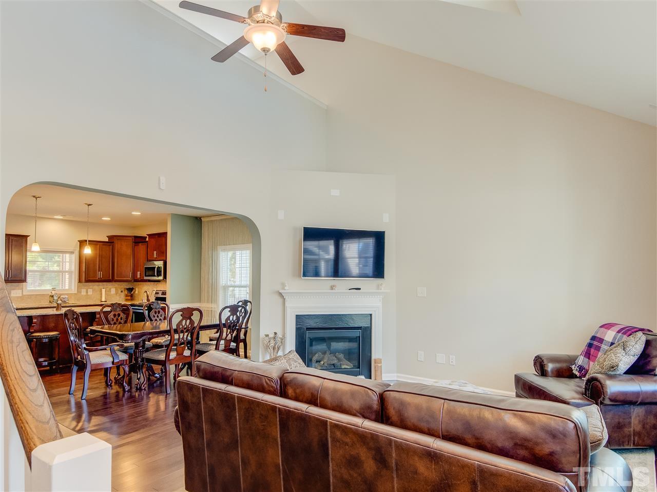 30 Mariners Point Way Garner, NC 27529 - Photo 6 of 25 View of Family Room to Dining Room. Gorgeous Gathering/Family Room has dramatic ceiling with ceiling fan. Features include direct vent gas fireplace, wall of windows and hardwood floor.