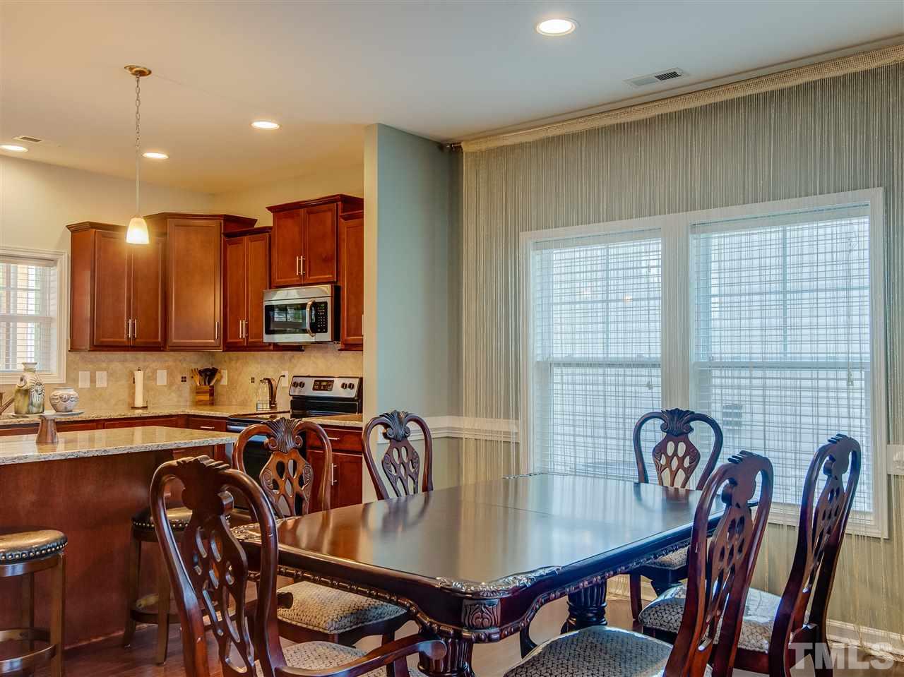 30 Mariners Point Way Garner, NC 27529 - Photo 7 of 25 Spacious Dining Room with Wall of Windows is perfectly designed and located between the Gathering/Family Room and Island Kitchen. Hardwood floors.