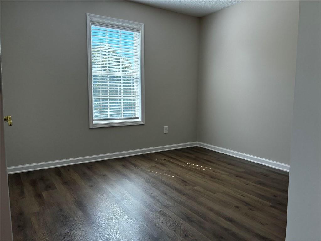 337 Madison Avenue Hampton, GA 30228 - Photo 15 of 32 a view of an empty room with wooden floor and a window