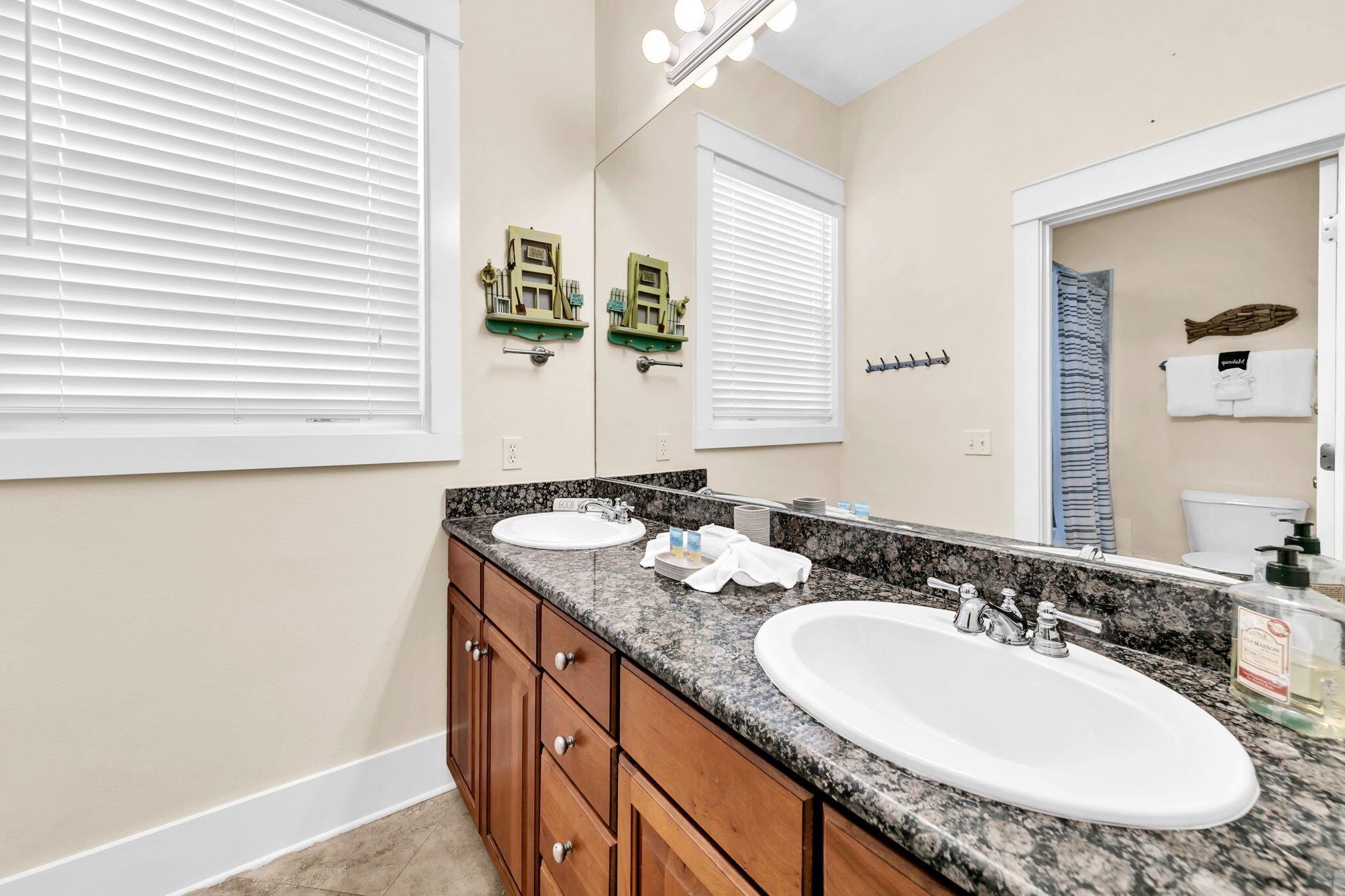 67 Sarasota Street Miramar Beach, FL 32550 - Photo 16 of 61 a bathroom with a granite countertop sink and a mirror