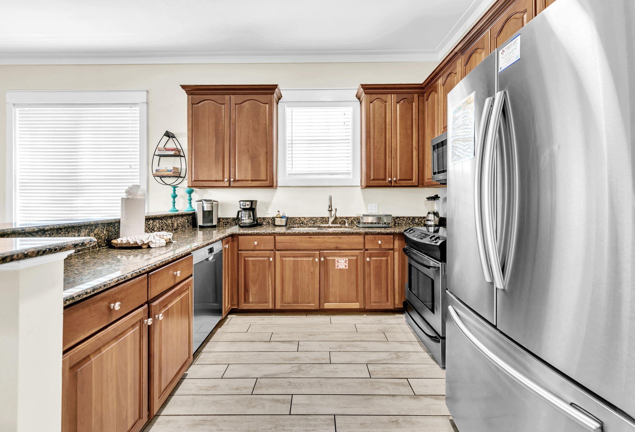 67 Sarasota Street Miramar Beach, FL 32550 - Photo 10 of 61 a kitchen with a refrigerator a sink and wooden cabinets