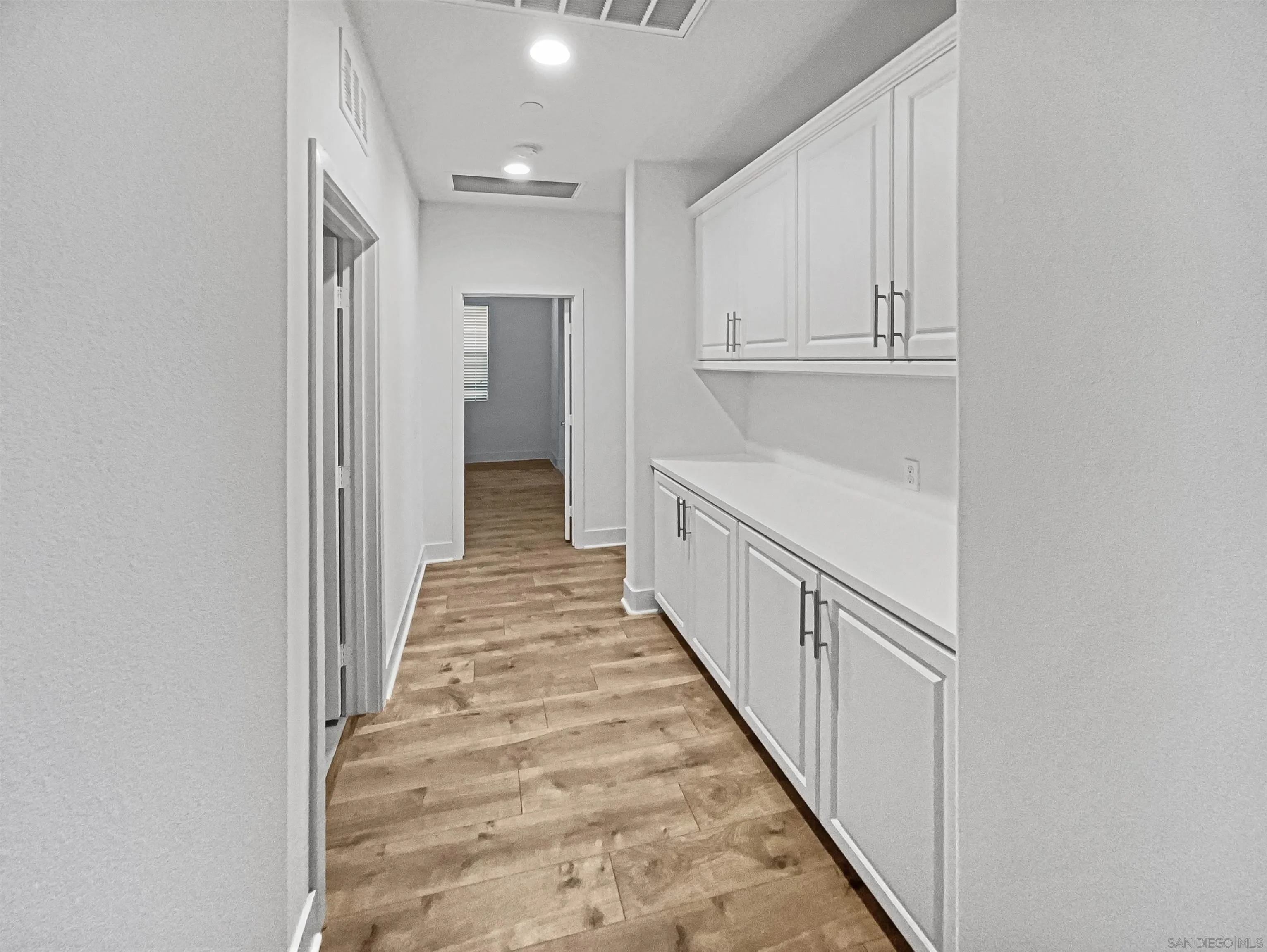 35751 Garrano Lane Fallbrook, CA 92028 - Photo 12 of 28 a view of a hallway with wooden floor and entryway