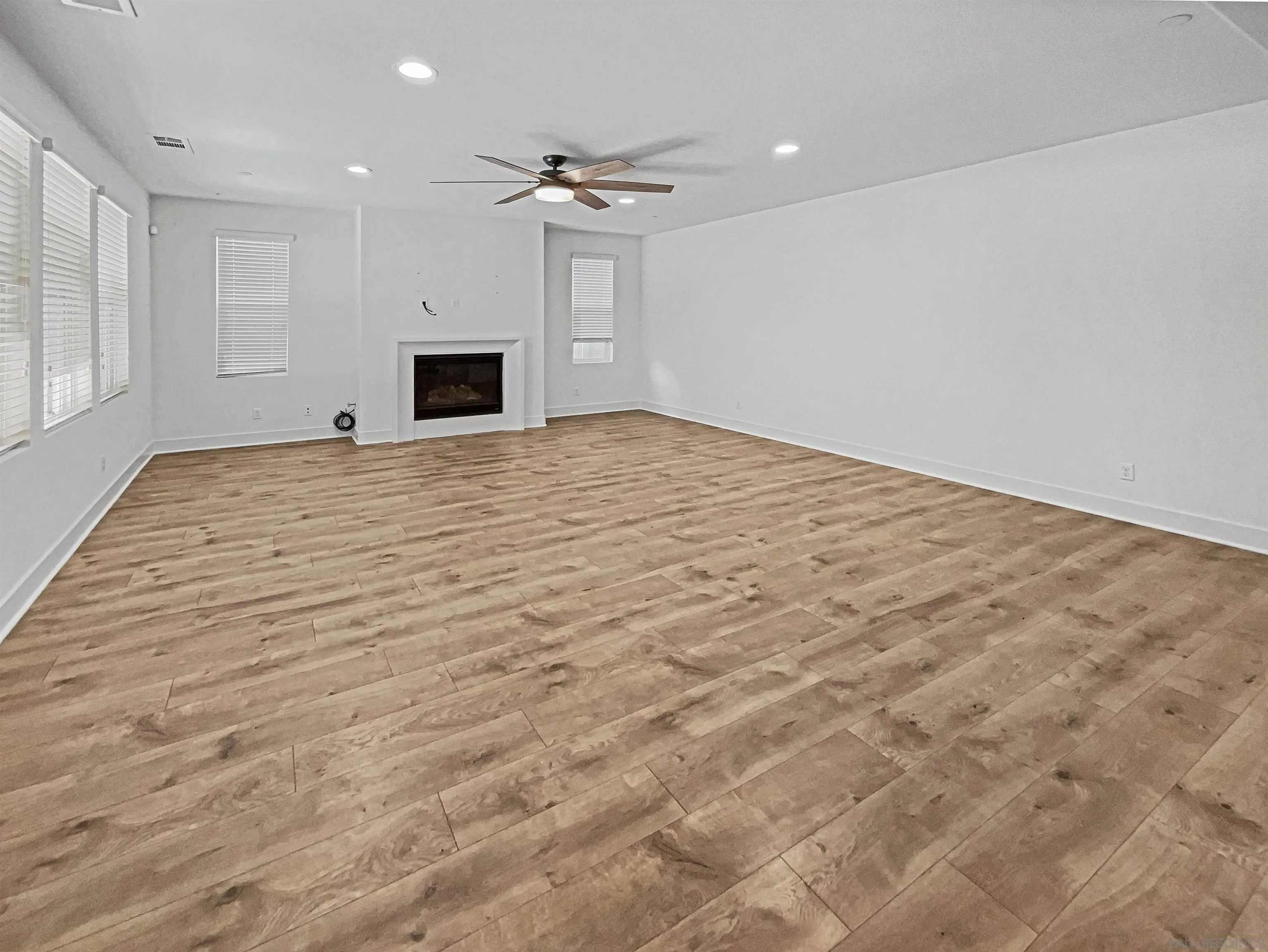 35751 Garrano Lane Fallbrook, CA 92028 - Photo 21 of 28 a big room with wooden floor and a ceiling fan