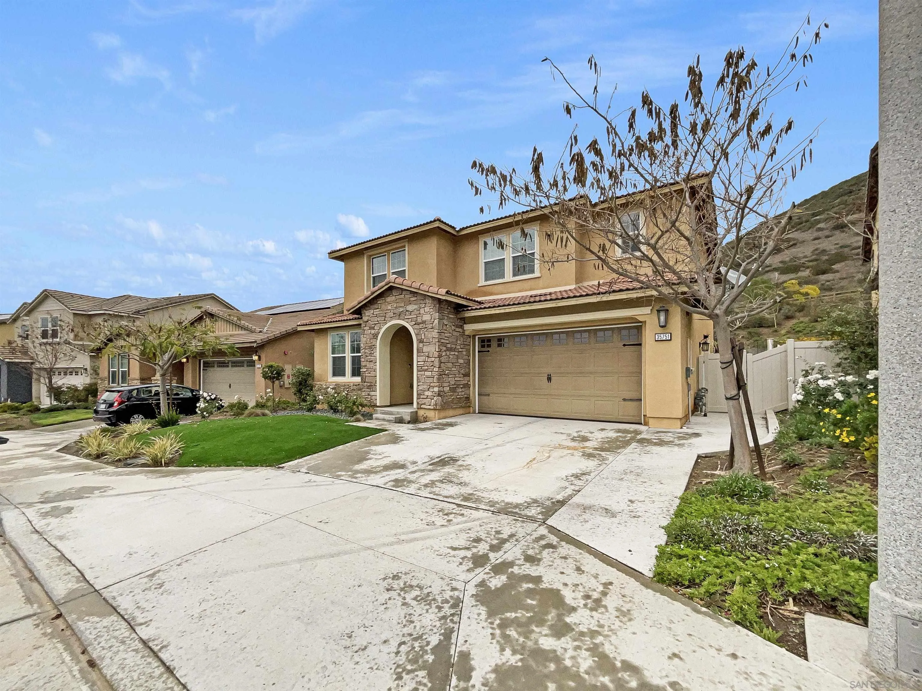 35751 Garrano Lane Fallbrook, CA 92028 - Photo 23 of 28 a front view of a house with a yard and garage