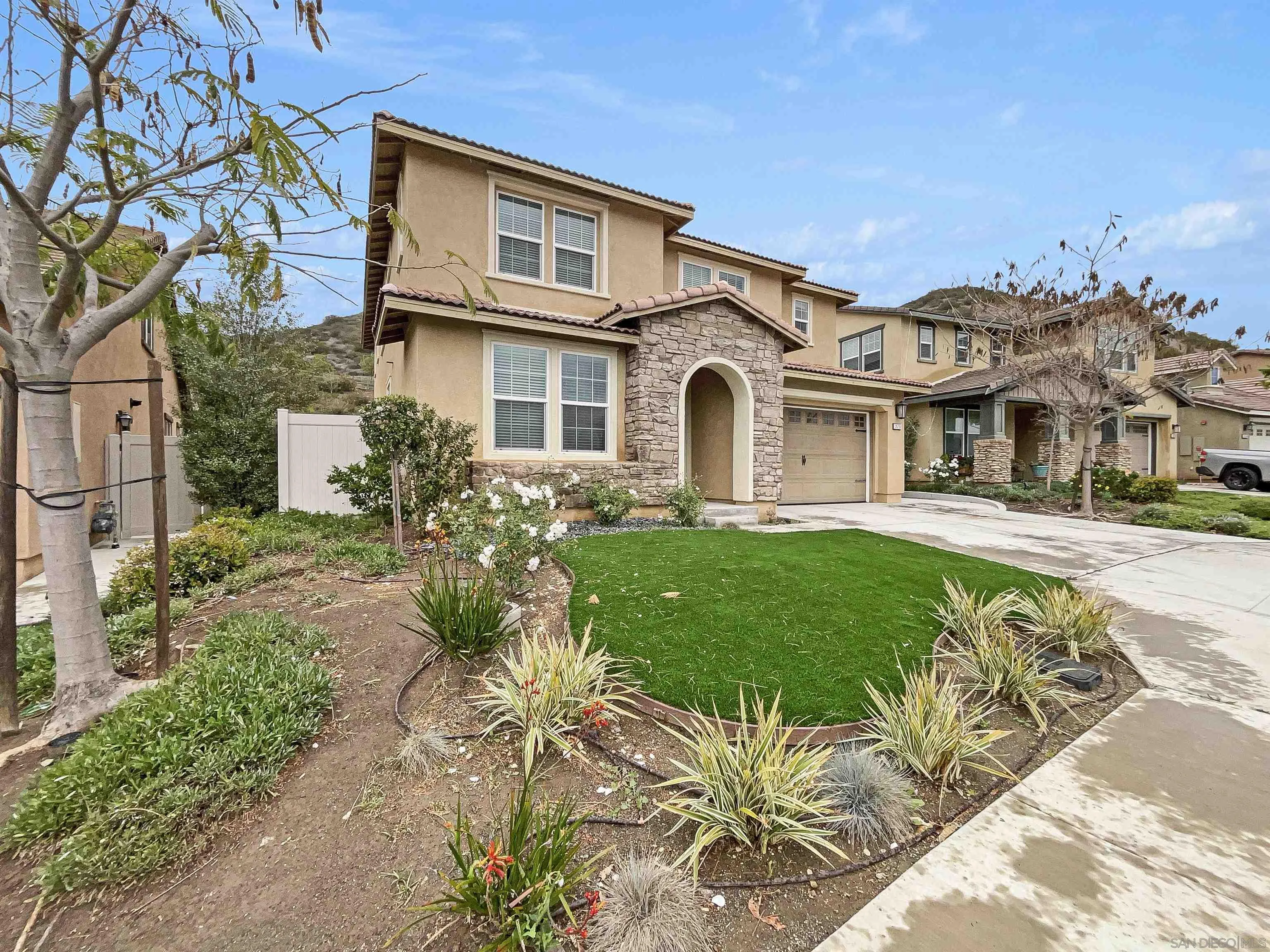 35751 Garrano Lane Fallbrook, CA 92028 - Photo 24 of 28 a front view of a house with a garden and plants