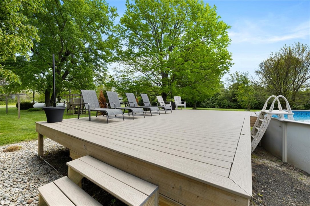 5120 Wheelock Road Troy, OH 45373 - Photo 43 of 67 This spacious backyard features a substantial deck and an inviting pool, perfect for outdoor enjoyment.