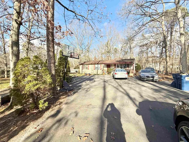 a view of a city street with a car parked on the road