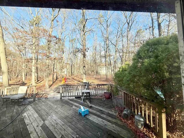 a view of a balcony with wooden floor and bench