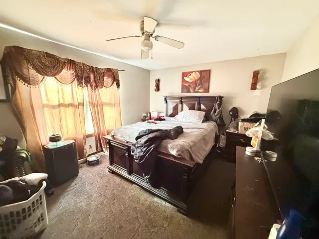 a bedroom with furniture and a window