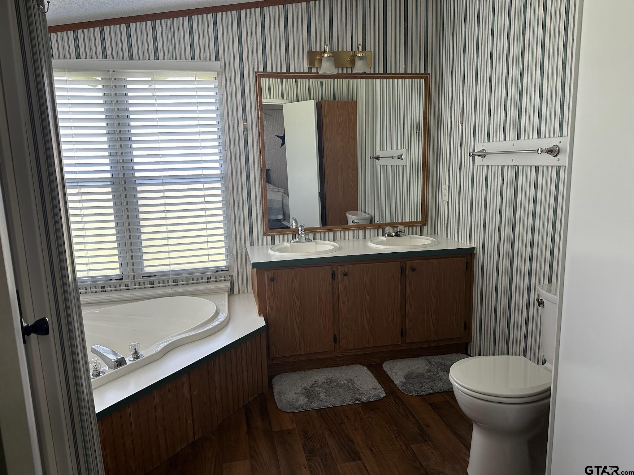 21516 Water Ridge Road Chandler, TX 75758 - Photo 12 of 48 a bathroom with a sink a toilet and tub