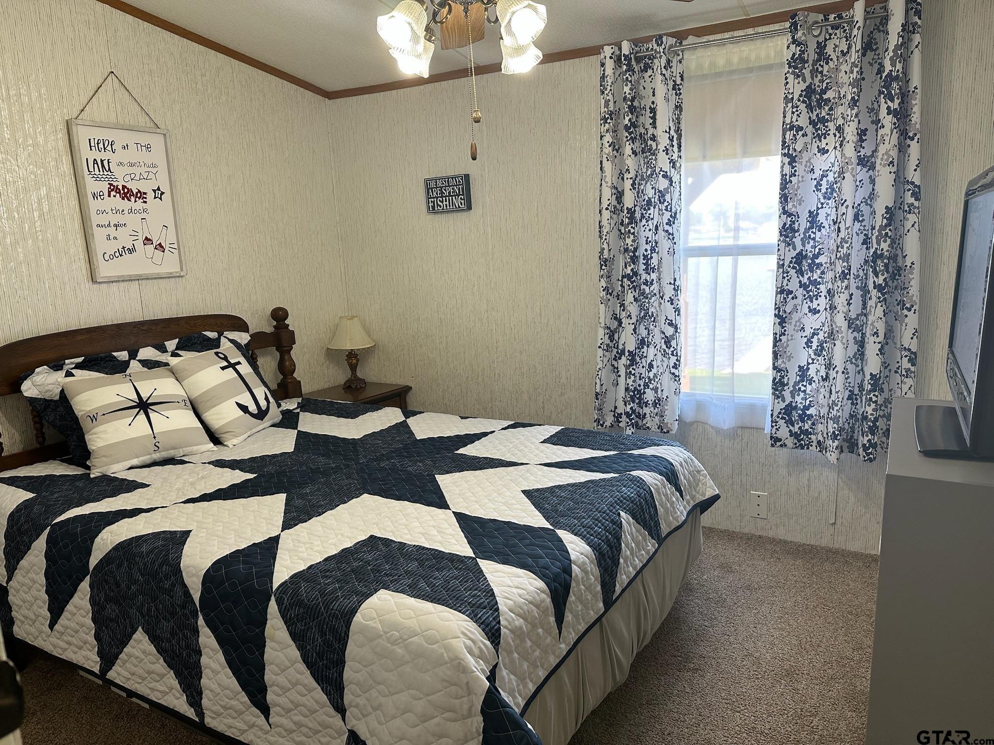 21516 Water Ridge Road Chandler, TX 75758 - Photo 14 of 48 a bedroom with bed and a window