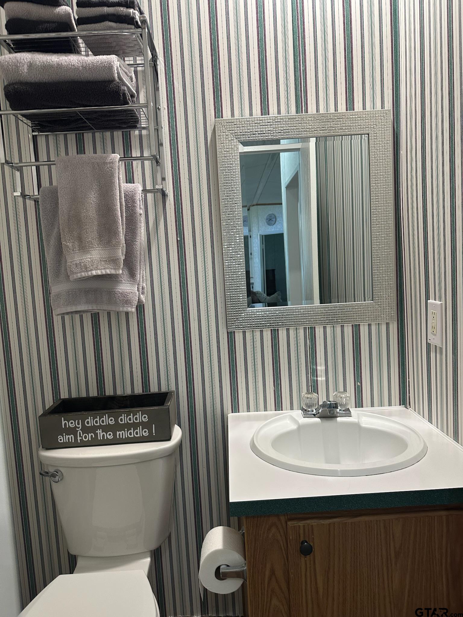 21516 Water Ridge Road Chandler, TX 75758 - Photo 16 of 48 a bathroom with a sink a toilet and mirror