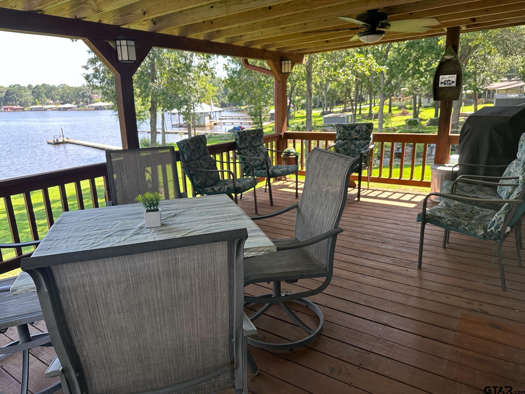 21516 Water Ridge Road Chandler, TX 75758 - Photo 21 of 48 a view of a balcony with chairs and wooden floor
