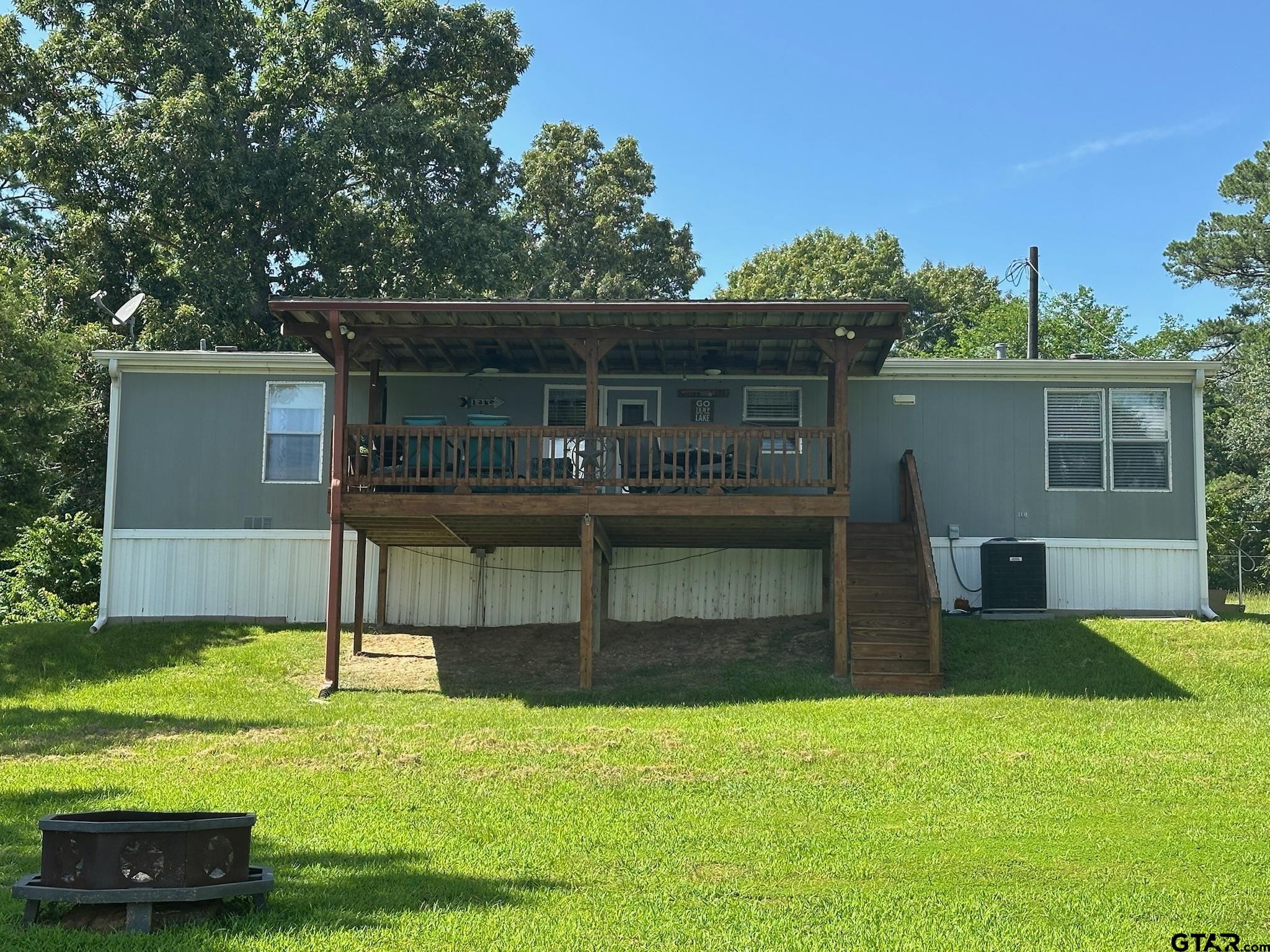 21516 Water Ridge Road Chandler, TX 75758 - Photo 23 of 48 a view of house with backyard outdoor seating and entertaining space