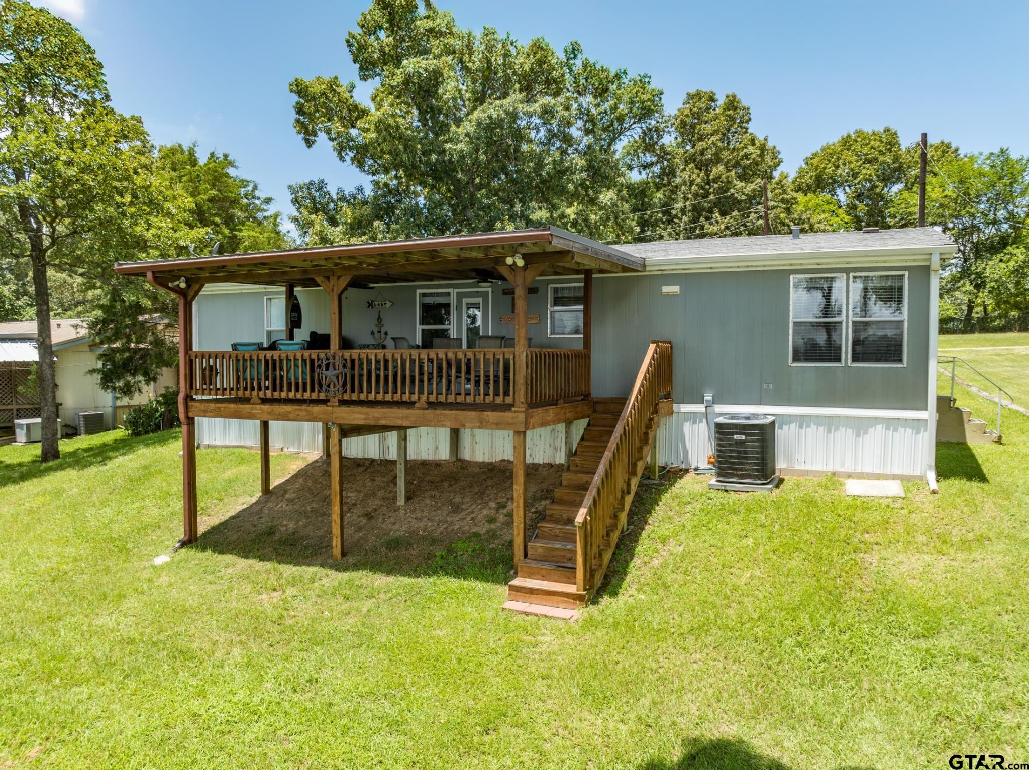 21516 Water Ridge Road Chandler, TX 75758 - Photo 27 of 48 a house view with a garden space