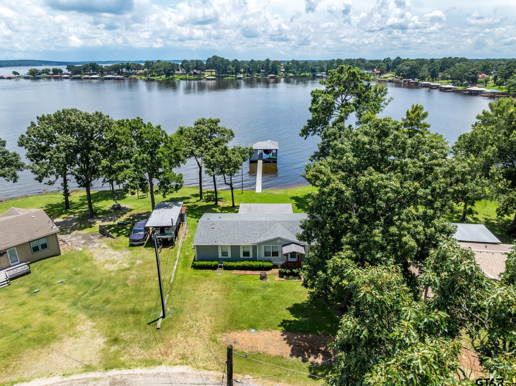21516 Water Ridge Road Chandler, TX 75758 - Photo 3 of 48 a view of a lake with a house next to a yard
