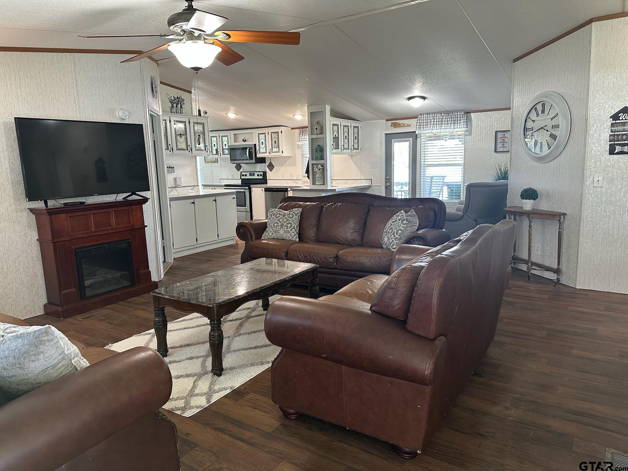 21516 Water Ridge Road Chandler, TX 75758 - Photo 4 of 48 a living room with furniture a flat screen tv and kitchen view