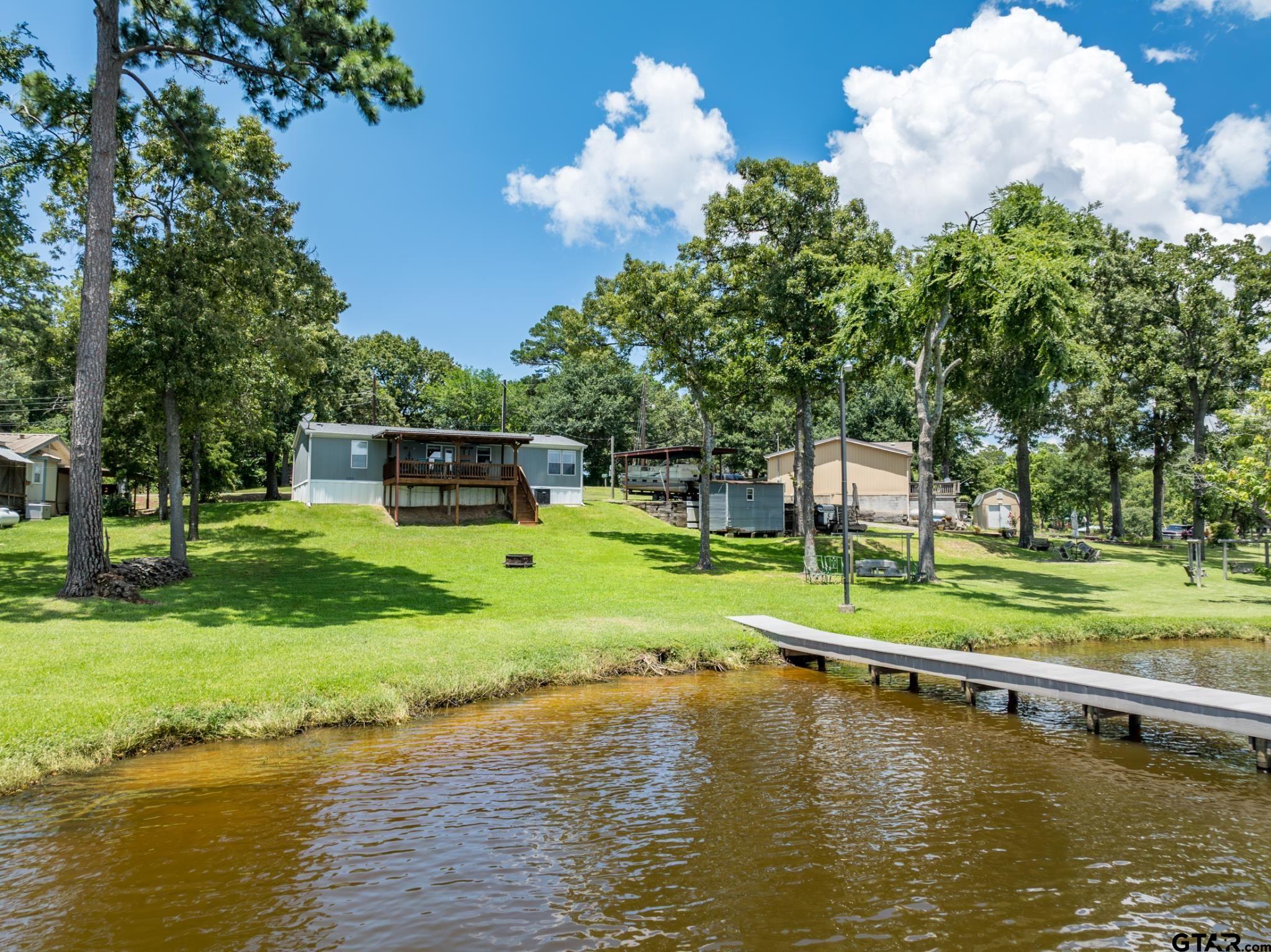 21516 Water Ridge Road Chandler, TX 75758 - Photo 41 of 48 a view of a house with pool and a yard