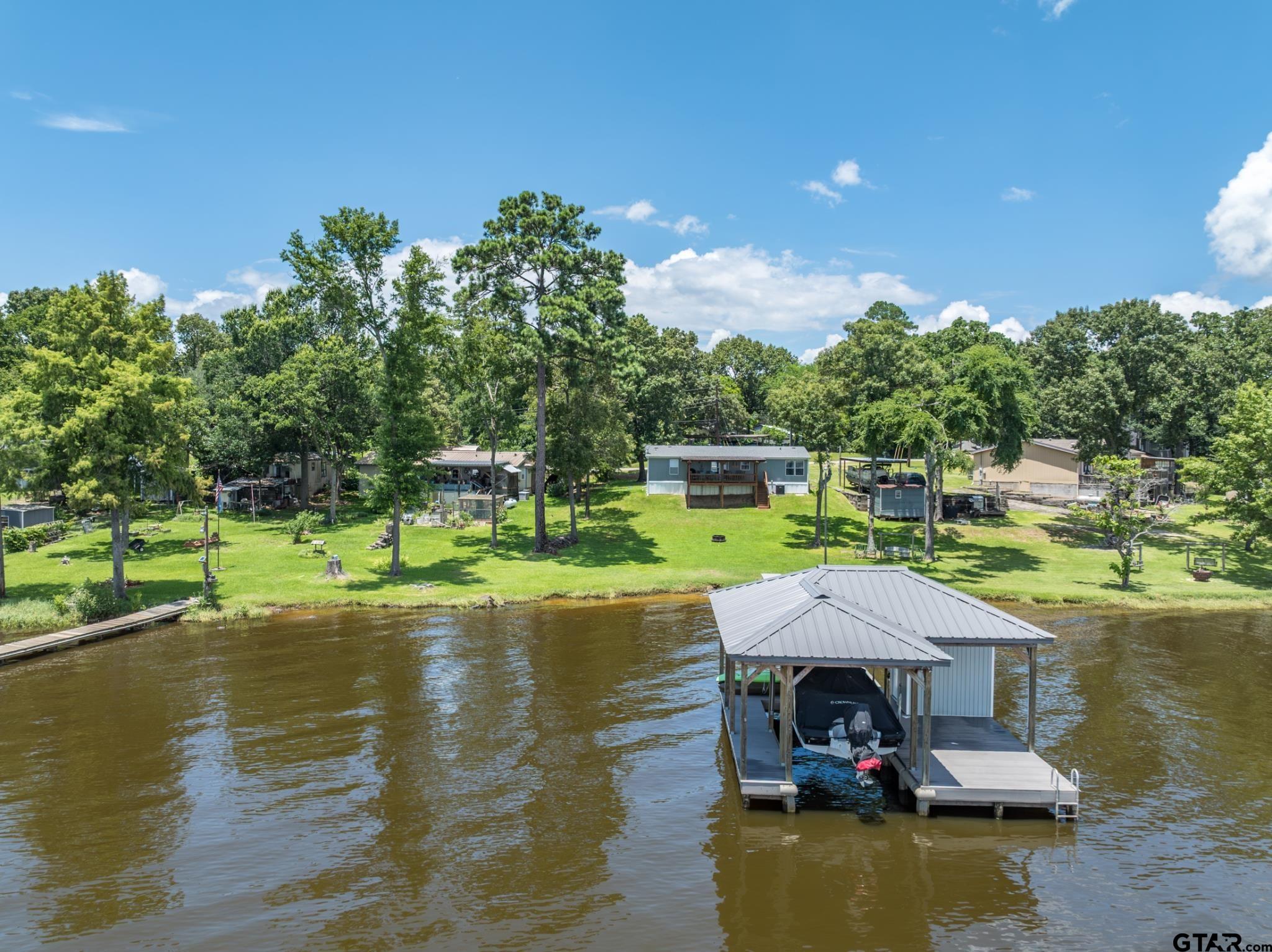 21516 Water Ridge Road Chandler, TX 75758 - Photo 42 of 48 a view of a lake with a house swimming pool and outdoor space