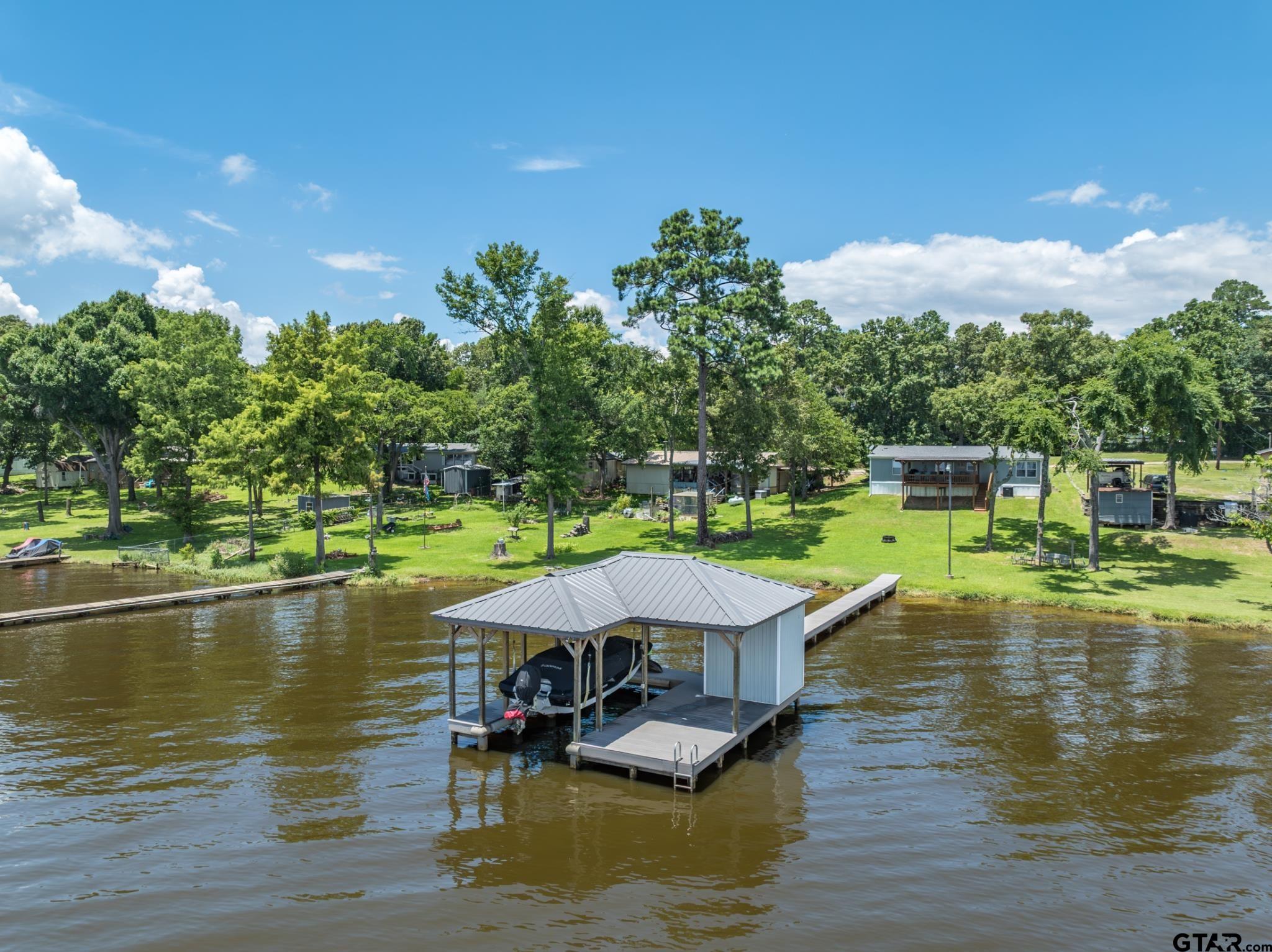21516 Water Ridge Road Chandler, TX 75758 - Photo 43 of 48 a view of a lake with couches chairs