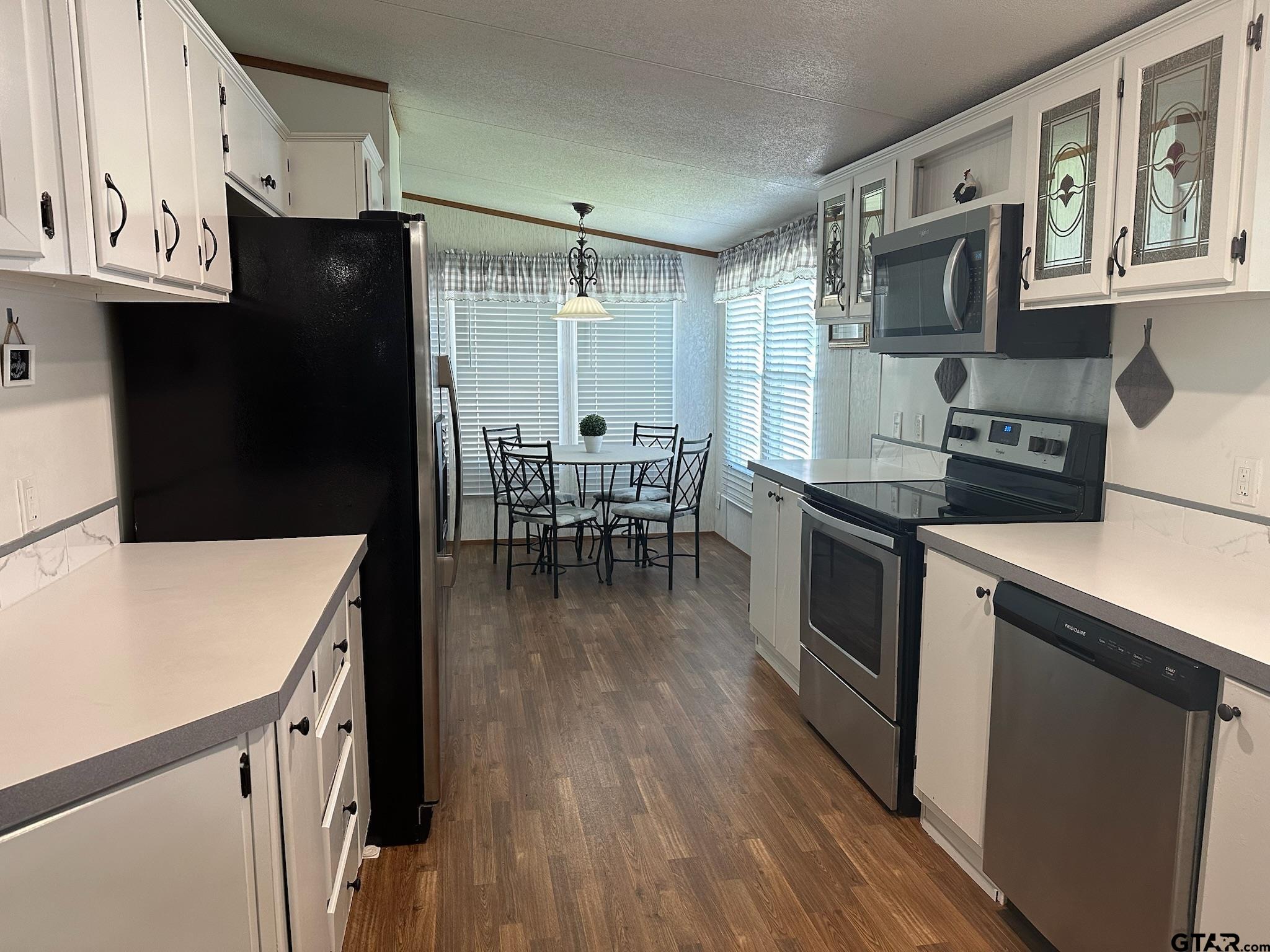 21516 Water Ridge Road Chandler, TX 75758 - Photo 7 of 48 a kitchen with granite countertop a refrigerator stove top oven and sink