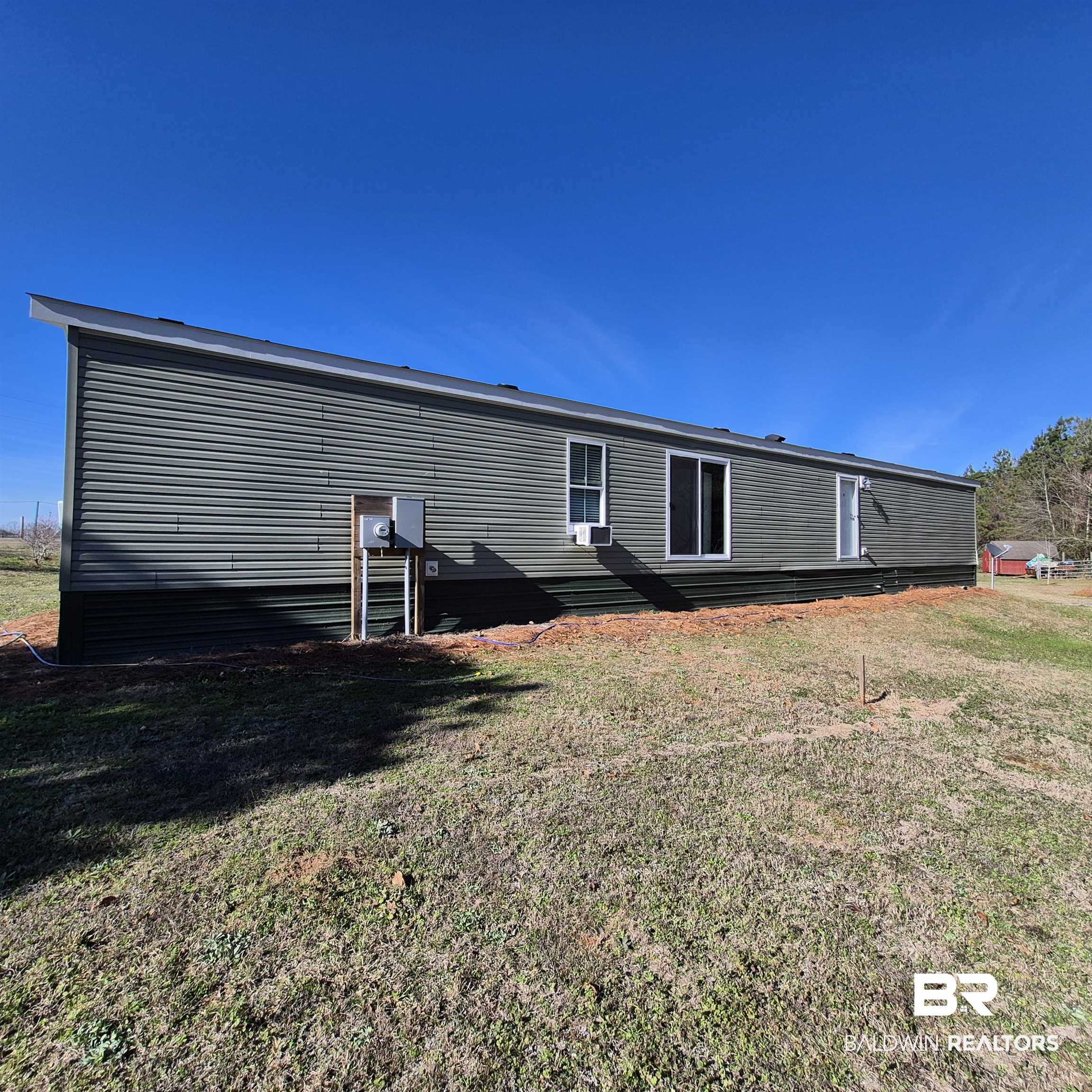 8867 Old Stage Road Repton, AL 36475 - Photo 31 of 37 Back of house featuring a yard