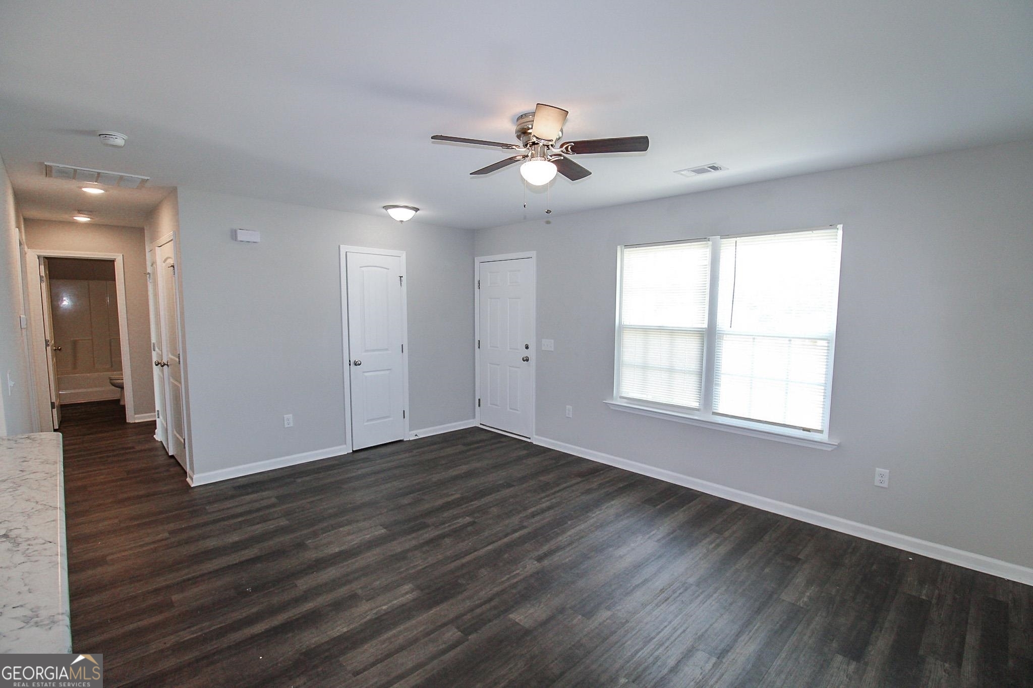 200 Evans Terrace Statesboro, GA 30458 - Photo 3 of 13 a view of an empty room with wooden floor and a window