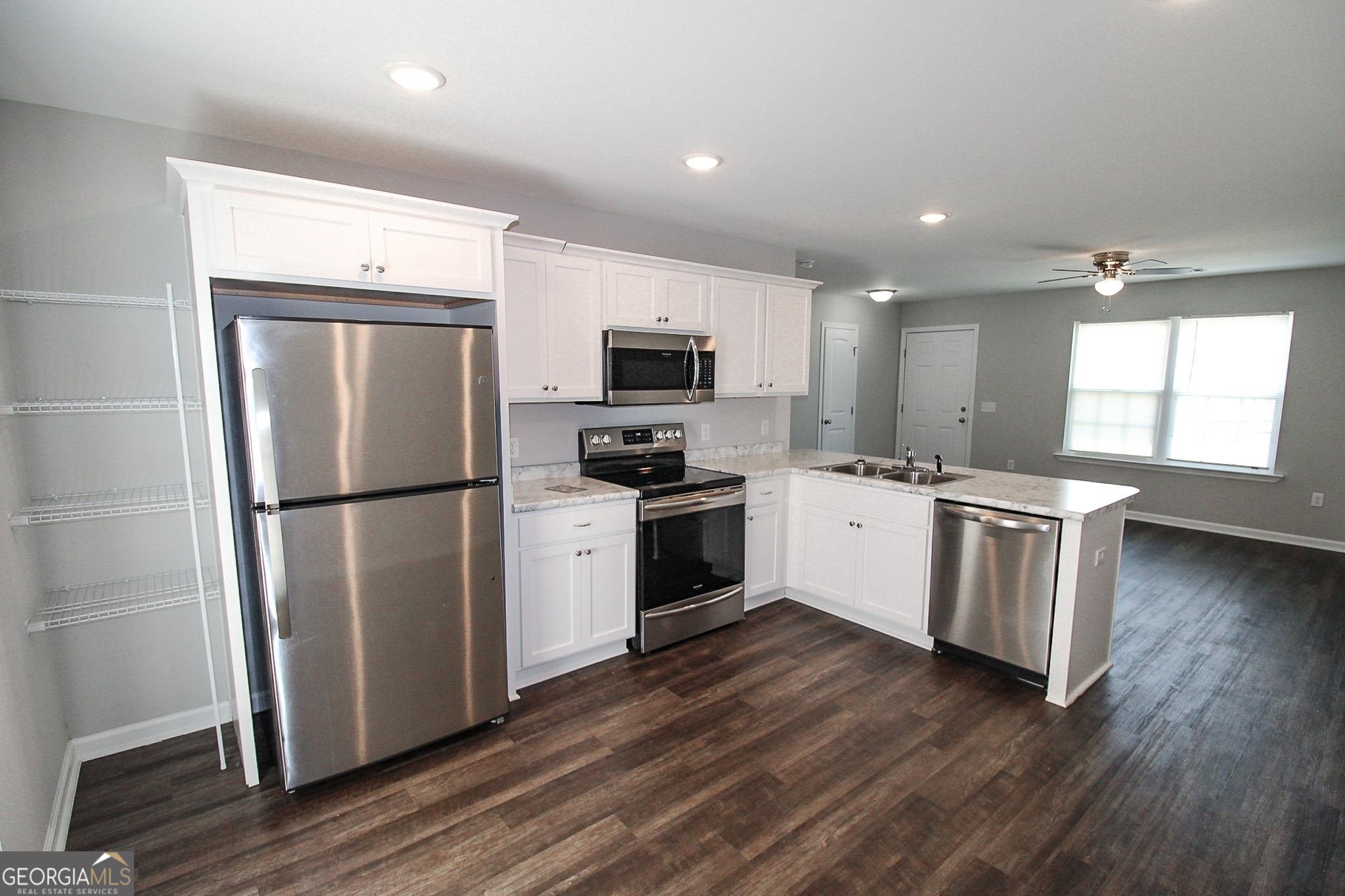 200 Evans Terrace Statesboro, GA 30458 - Photo 5 of 13 a kitchen with a refrigerator and a stove top oven