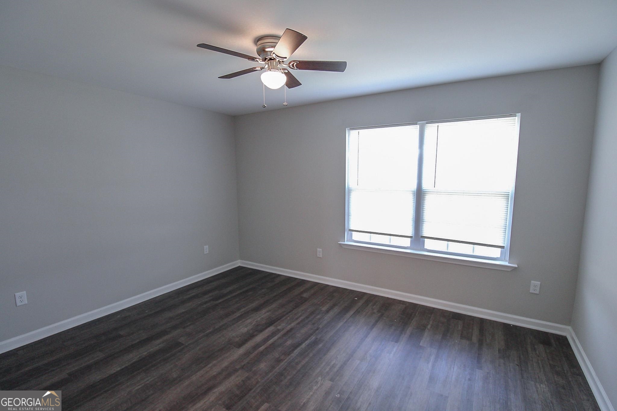 200 Evans Terrace Statesboro, GA 30458 - Photo 6 of 13 an empty room with wooden floor and windows